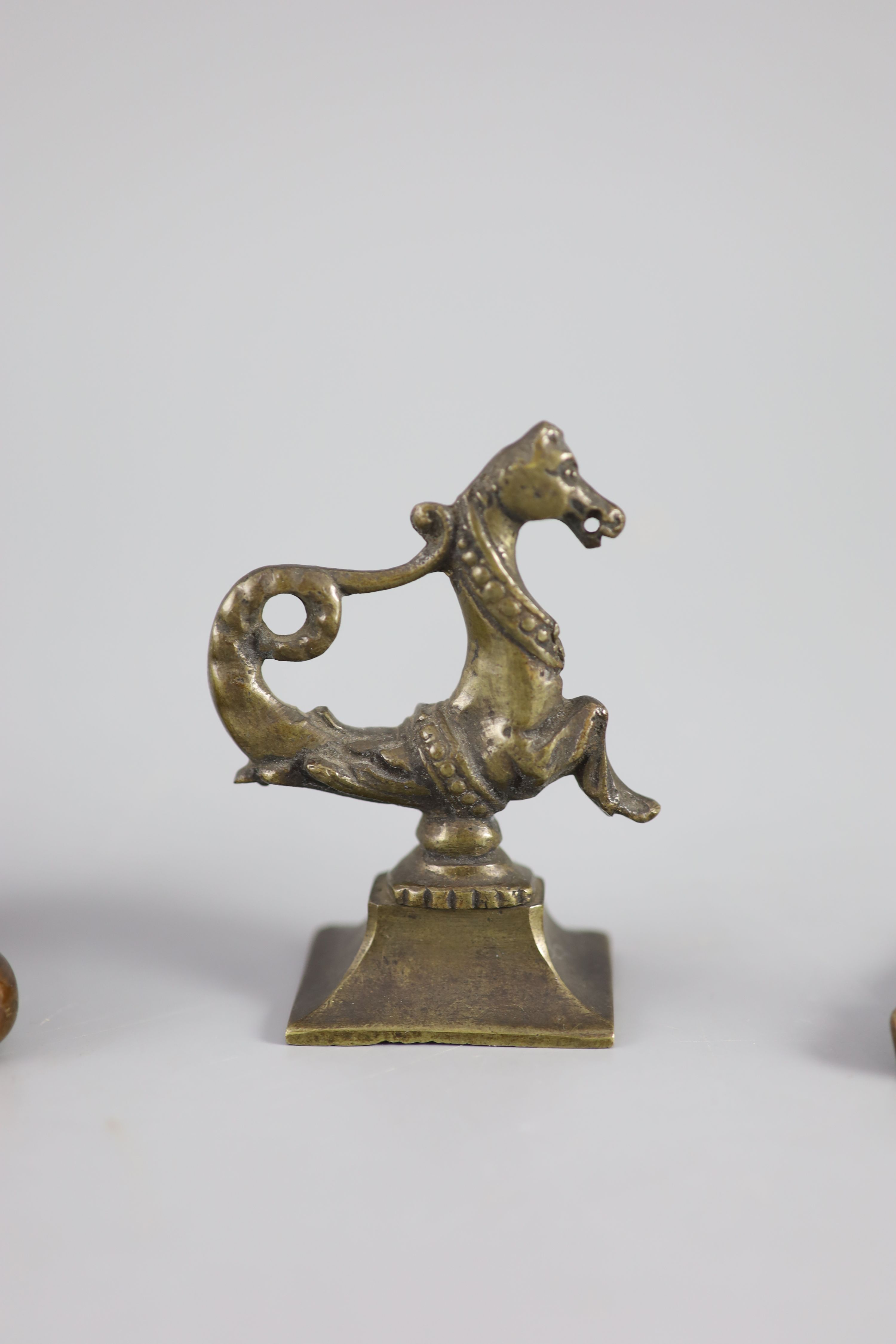 A near pair of William IV bronze figures of a monarch, a Venetian seahorse finial and a brass tobacco box.